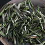 Silver Needle White Tea loose leaf buds in a white ceramic bowl