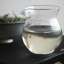 Silver Needle White Tea brewed in a glass teacup with pale golden liquor